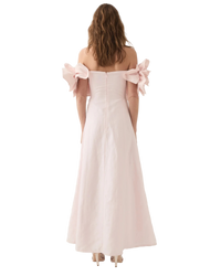 Pink off-shoulder dress with 3D floral details on a white background