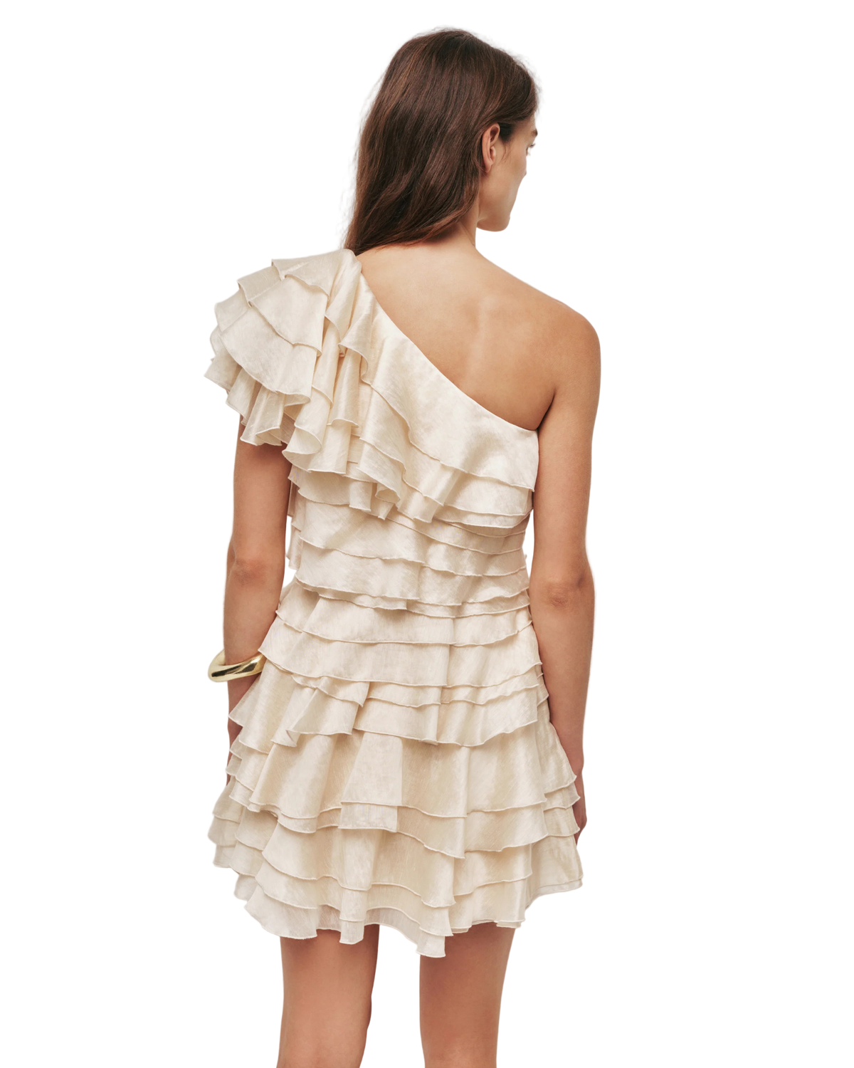 Woman wearing a one-shoulder ruffled dress against a plain background