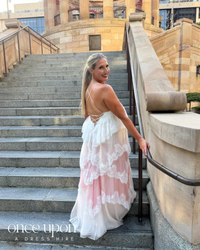 Aje Ophelia Lace Gown in pink and cream multi, lifestyle back view on sandstone stairs